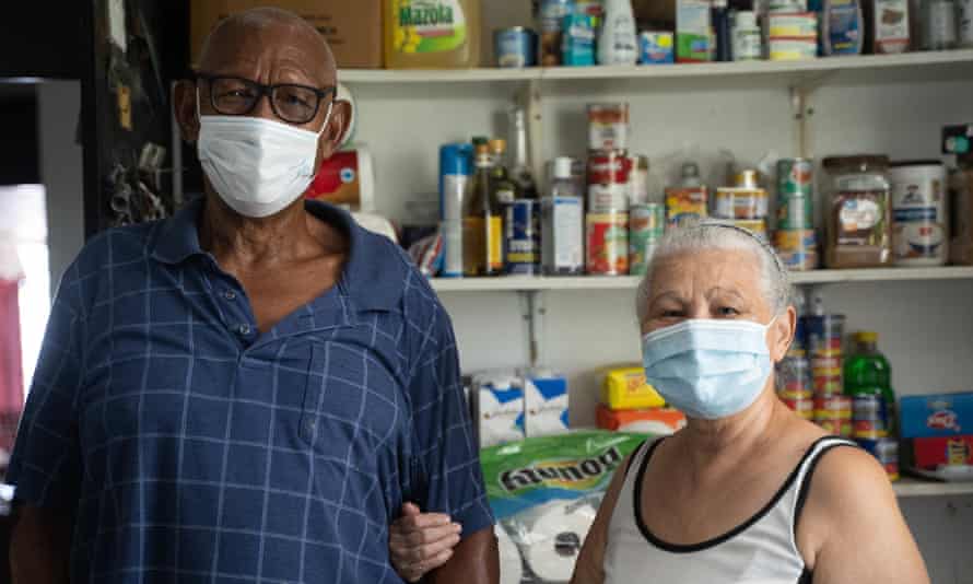 Jose Vazquez and his wife, Margarita Velazquez, in the supply room of their solar-powered residence in Barrio Jobos in Guayama.