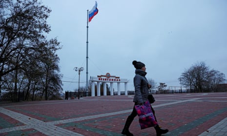 A woman walks through a square in Melitopol, Russian-controlled Ukraine.