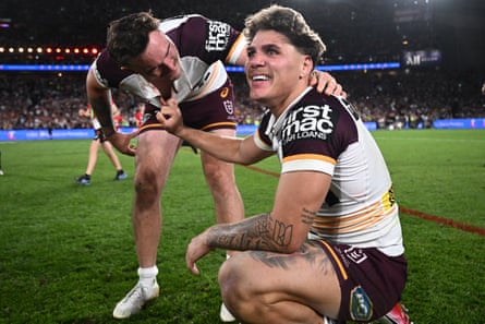 Kobe Hetherington rushes to Reece Walsh after the final whistle blows and Brisbane win the NRL grand final.