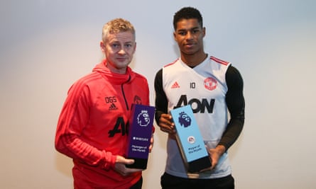 Ole Gunnar Solskjaer and Marcus Rashford pose with their manager and player of the month awards for January 2019