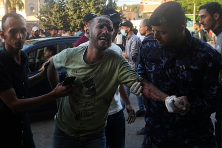 Palestinians wounded in the Israeli bombardment of the Gaza Strip are brought to a treatment room of al Aqsa hospital on Deir al Balah on 6 November