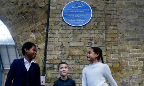 Great-grandchildren of Wilston Samuel Jackson, Josiah Jackson, Lawrence Hollingsworth and Sofia Hollingsworth beneath the new blue plaque honouring him.