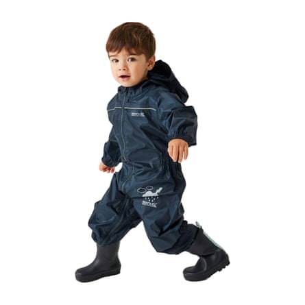 A young person in a navy Regatta Kids’ waterproof puddle Suit.