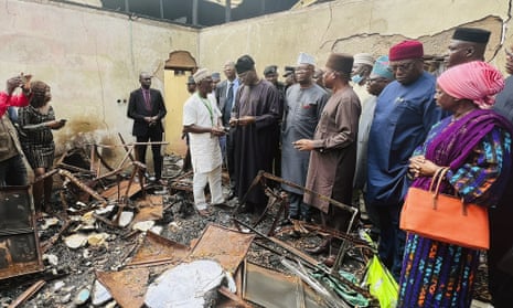 Electoral commission staff assess damage on 10 November 2022 at the Inec office destroyed by assailants in Abeokuta, Nigeria.