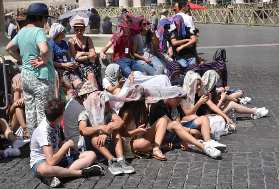 People shelter from the sun in St Peter’s Square, Vatican City.