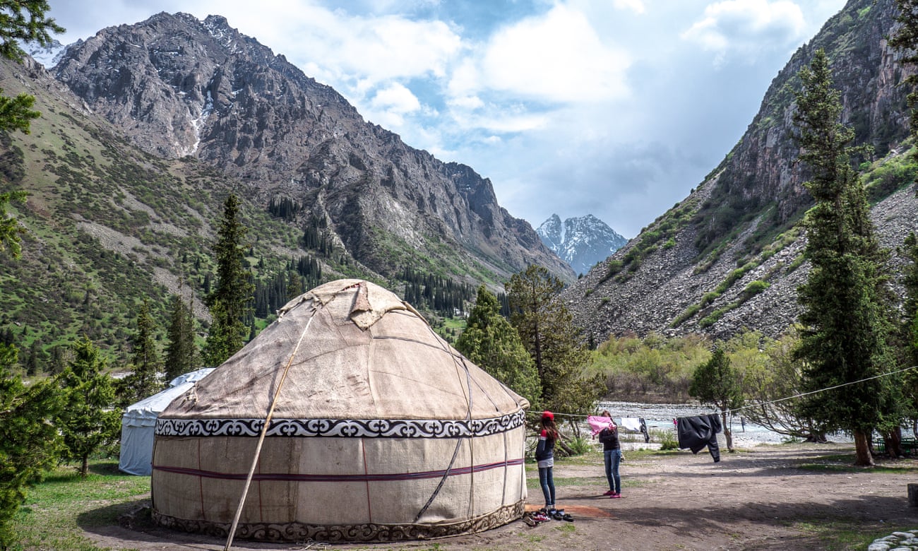 The Ala Archa region of Kyrgyzstan. Yurts with entire families are positioned next to the rivers.