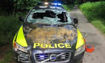 The damage caused to a police car by the truck
