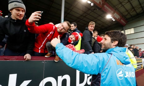 The Lincoln City manager, Danny Cowley, celebrates with fans after his team’s historic FA Cup victory over Burnley at Turf Moor.