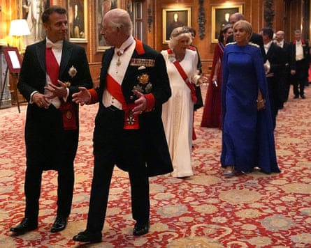 Emmanuel Macron and Charles walking together entering the banquet, Camilla and Brigitte Macron behind