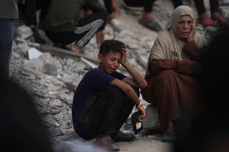 Palestinians mourn during the funeral of people who were killed while trying to reach aid trucks entering northern Gaza through the Zikim crossing with Israel, at Shifa Hospital, in Gaza City, Saturday, July 26, 2025.