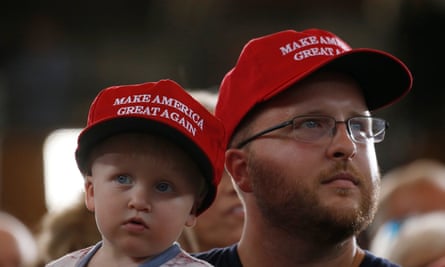 A man and child wait for Trump to speak