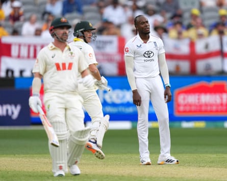 England’s Jofra Archer looks dejected as Australia’s Marnus Labuschagne and Travis Head run between the wickets in Perth