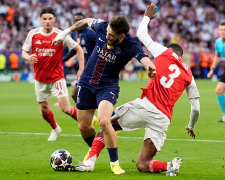 Paris Saint-Germain’s Khvicha Kvaratskhelia (left) is fouled by Arsenal’s Cristhian Mosquera resulting in a penalty
