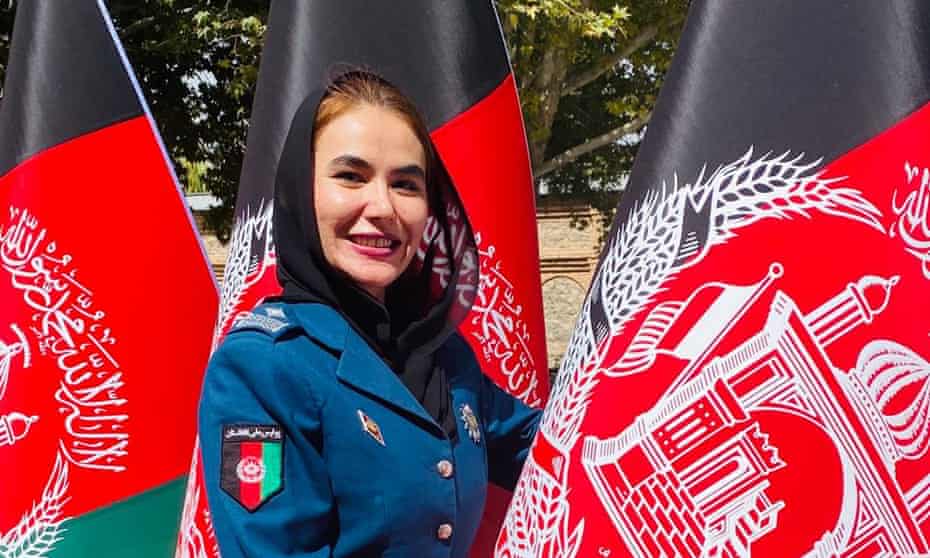 Afghan policewoman Gulafroz Ebtekar pictured in uniform among Afghanistan flags