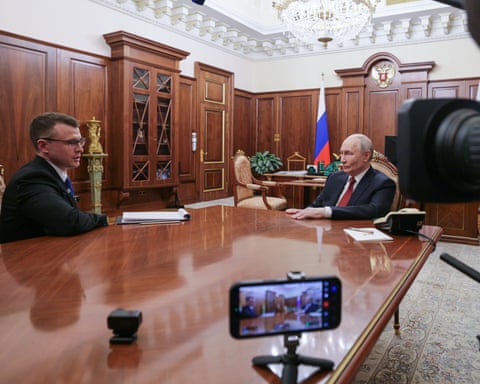 Vladimir Putin gives an interview in a state room