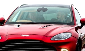 Prince Charles (left) drives the company’s first SUV, the Aston Martin DBX, during his visit to its new manufacturing plant in St Athan, Wales.
