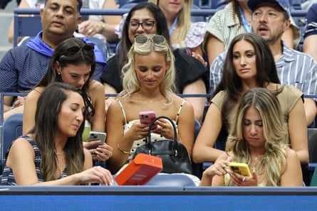 Fans look at their phones during the 2025 US Open women's singles third-round match between Jessica Pegula and Victoria Azarenka