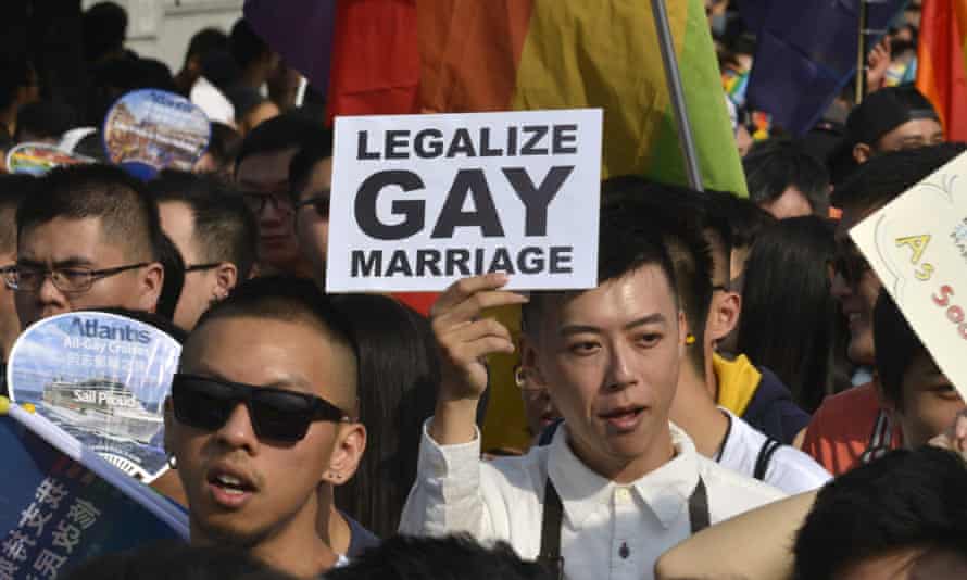 A supporter of same-sex rights holds a sign during the Taipei gay pride parade