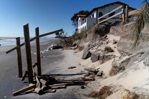 A coastal home after part of its back garden was washed away during storm surges on Waihi Beach