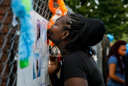 The aunt of Jahnae Patterson kisses a picture of her niece during a vigil.