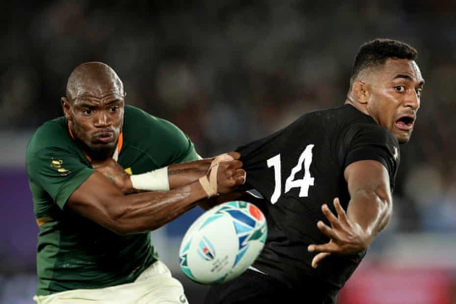 All Blacks winger Sevu Reece evades the tackle of South Africa’s Makazole Mapimpi to offload the ball at International Stadium Yokohama.