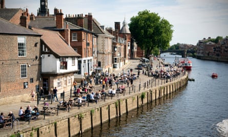 People drink in the bars on the banks of the River Ouse in York town centre in North Yorkshire.