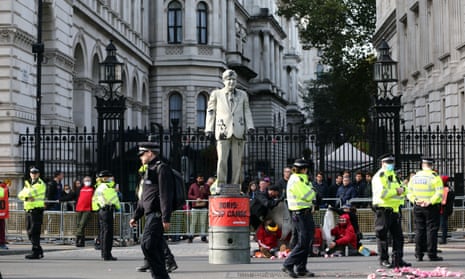 Greenpeace blocks Downing Street with a Boris Johnson statue covered in oil in protest at drilling at the Cambo oilfield off Shetland