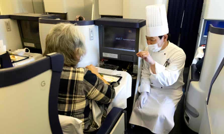 The chef speaks with a customer on a parked All Nippon Airways plane at Haneda airport in Tokyo.