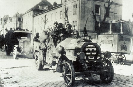 a paramilitary unit drives on a street