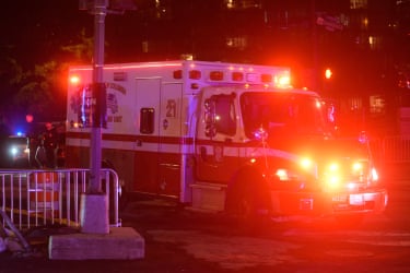 An ambulance departs outside the White House Correspondents Dinner.