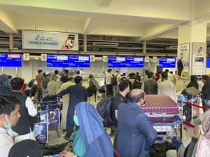 People gather at airport check-in desks