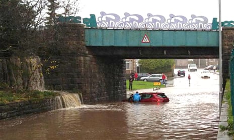 Car stuck in flood water under a railway bridge in Seaton, Cumbria, following heavy rain on Wednesday.