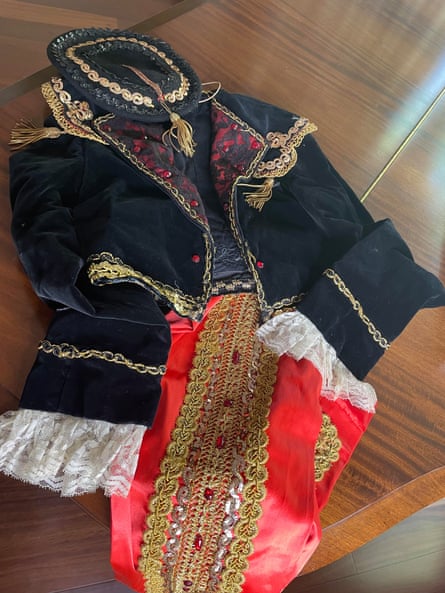 A black and velvet matador-style dress with gold trimmings
