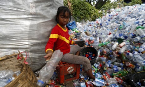 A girl recycles plastic bottles in Indonesia