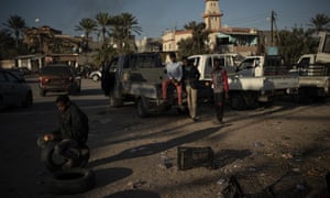 People from Niger looking for jobs wait at a crossroads in the outskirts of Tripoli, Libya.