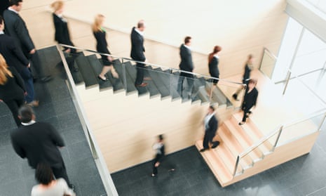 Businesspeople walking down office staircase