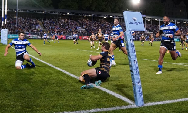 Josh Bassett slides in to score one of his two tries in Wasps’ victory over Bath.