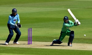 Ireland’s Curtis Campher bats as England wicketkeeper Jonny Bairstow looks on.