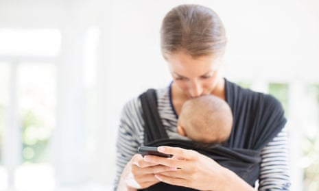 Mother with baby boy using cell phone.