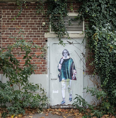 A collage-mural portrait of Gisèle Pelicot walking, posted on a door in an ivy-covered brick wall