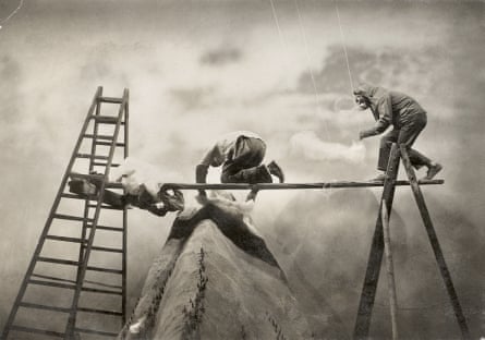 The film-makers creating special effect clouds above a model mountaintop.