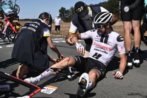 Team Sunweb rider Nicolas Roche is helped by medics after crashing.