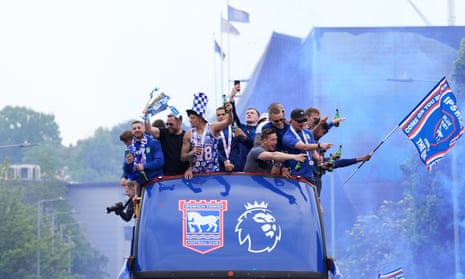 Ipswich players celebrate during an open-top bus parade around the town.