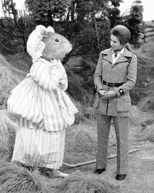 Managing to look impossibly chic in a check trouser suit while meeting Mrs Tittlemouse from Beatrix Potter in 1970.