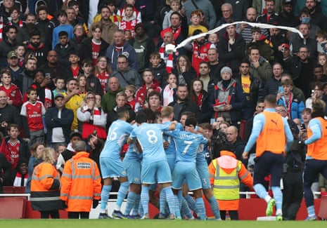 A toilet roll is thrown as Manchester City celebrate their winning goal in front of the Arsenal fans.