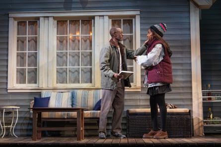 A father and a daughter character on stage with an exterior of a house as the set.