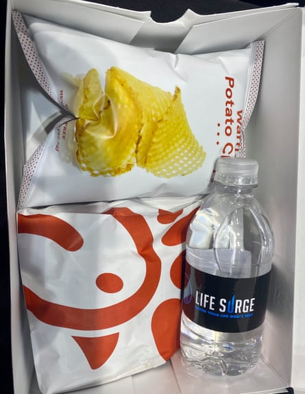 box of food with sandwich, chips and water