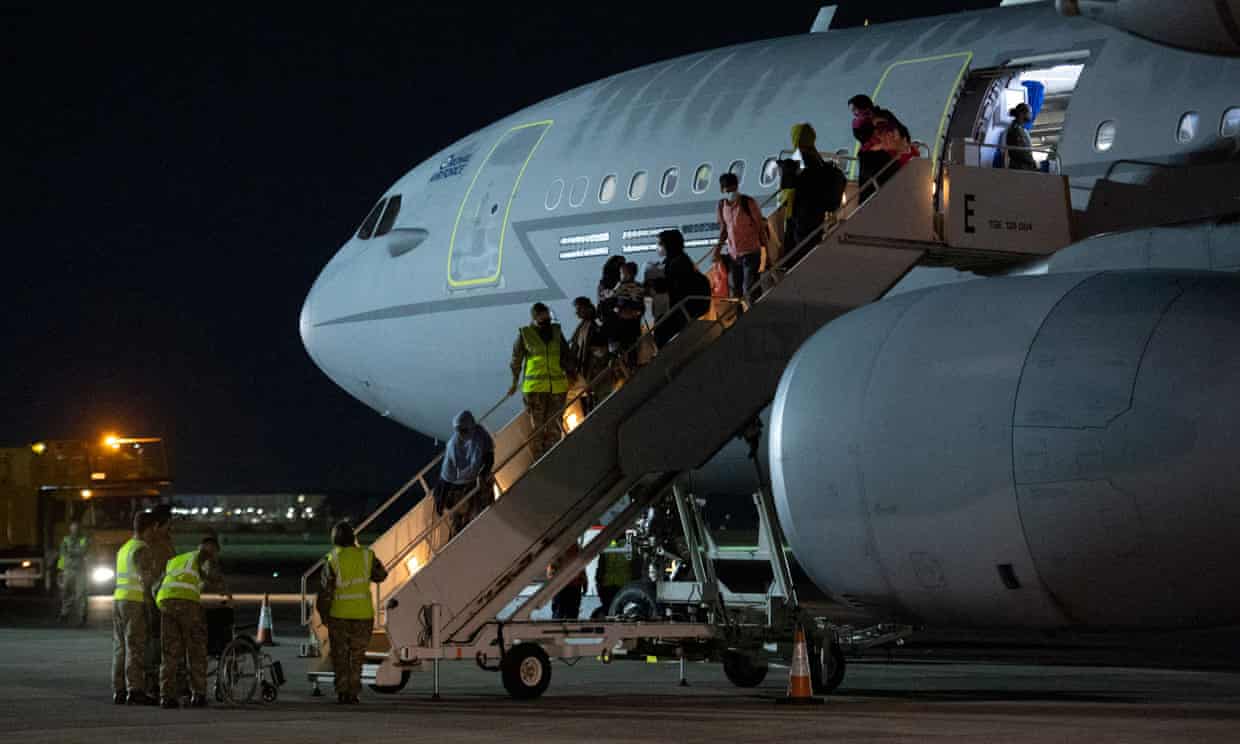 Passengers evacuated from Afghanistan disembark from a British aircraft at RAF Brize Norton in southern England on 24 August. Photograph: Justin Tallis/AFP/Getty Images
