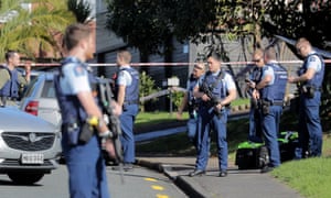 Armed police gather at the scene of a shooting incident following a routine traffic stop in Auckland, New Zealand