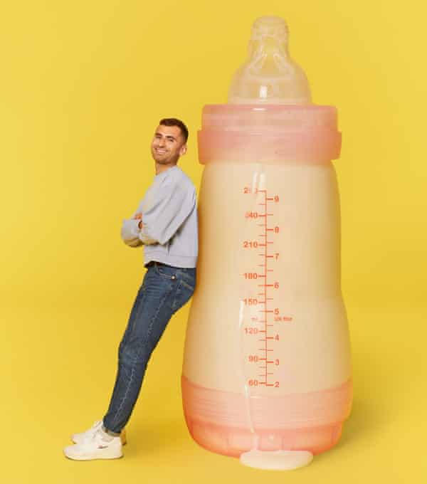 Michael Segalov sits on an oversized bottle for a baby